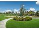 Community playground with swings, slide, and climbing structure set in a grassy area with lush landscaping at 3814 Scrub Creek Run, Lakewood Ranch, FL 34211