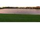 Lush green lawn slopes gently toward a tranquil pond surrounded by manicured landscaping at 3814 Scrub Creek Run, Lakewood Ranch, FL 34211