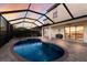 Gorgeous screened-in lanai with a sparkling pool, heated spa, and an outdoor dining area at 3814 Scrub Creek Run, Lakewood Ranch, FL 34211