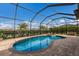Screened-in pool and hot tub with brick patio and privacy landscaping at 3814 Scrub Creek Run, Lakewood Ranch, FL 34211