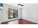 Bedroom with hardwood floors, a ceiling fan and a large window at 4001 Beneva Rd # 343, Sarasota, FL 34233