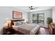 Bedroom featuring hardwood floors, ceiling fan and a large window at 4001 Beneva Rd # 343, Sarasota, FL 34233