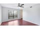 Bedroom featuring hardwood floors, ceiling fan and a large window at 4001 Beneva Rd # 343, Sarasota, FL 34233
