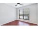 A bedroom featuring wood floors, grey painted walls, and a single window with adjustable blinds at 4001 Beneva Rd # 343, Sarasota, FL 34233