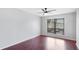 Bedroom with hardwood floors, a ceiling fan and a large window at 4001 Beneva Rd # 343, Sarasota, FL 34233