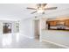 Open-concept living area features tile floors, a ceiling fan, and a pass-through to the kitchen at 4001 Beneva Rd # 343, Sarasota, FL 34233