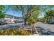 Exterior view showing parking and a well-maintained landscape with mature trees and a bench seating area at 4001 Beneva Rd # 343, Sarasota, FL 34233