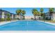 Outdoor tennis court with palm trees and landscaping adding to the appeal of this community at 4001 Beneva Rd # 343, Sarasota, FL 34233