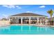 Community pool view with shaded structure, tables, and lounge chairs at 4021 Direct Greeen Pl, Bradenton, FL 34208