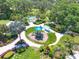 Aerial view of community playground featuring colorful slides and ample shade, perfect for Gathering fun at 4107 Pine Meadow Dr, Parrish, FL 34219