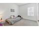 Simple bedroom featuring a single bed, a neutral color scheme, and a bright window, creating a calming and peaceful space at 4107 Pine Meadow Dr, Parrish, FL 34219