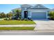 Charming single-story home featuring a well-manicured lawn, a two-car garage, and tasteful landscaping at 4107 Pine Meadow Dr, Parrish, FL 34219