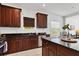 Modern kitchen featuring cherry wood cabinets, granite countertops, and stainless steel appliances at 4107 Pine Meadow Dr, Parrish, FL 34219
