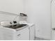 Bright laundry room featuring modern Samsung washer and dryer, plus wire shelving for storage at 4107 Pine Meadow Dr, Parrish, FL 34219