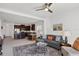 Stylish living room offers comfortable seating, a ceiling fan, and seamlessly connects to the modern kitchen at 4107 Pine Meadow Dr, Parrish, FL 34219