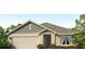 Charming single-Gathering home featuring a two-car garage, attractive landscaping, and a welcoming front porch at 4108 112Th E St, Palmetto, FL 34221