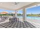 Open air poolside patio under a large covered space with tables and chairs and a ceiling fan at 4108 112Th E St, Palmetto, FL 34221