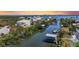 Aerial view of waterfront homes with docks, boat lifts, lush landscaping, and open water at 4109 Cobia Ct, Palmetto, FL 34221