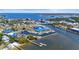 Aerial view of marina with boats docked, tennis courts, and waterfront homes in the distance at 4109 Cobia Ct, Palmetto, FL 34221