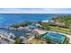 Overhead shot of marina with boats, tennis courts, parking, and blue waterfront building at 4109 Cobia Ct, Palmetto, FL 34221