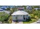 Stunning aerial view of a two-story home with a metal roof, pool, and attached two-car garage at 4109 Cobia Ct, Palmetto, FL 34221