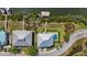 Bird's-eye view of two houses, one with a private swimming pool and private boat dock at 4109 Cobia Ct, Palmetto, FL 34221