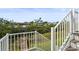 Backyard view from the staircase showing a canal, lush greenery, and neighborhood homes at 4109 Cobia Ct, Palmetto, FL 34221
