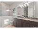 Modern bathroom with double vanity, granite countertops, and a walk-in shower with elegant tile work at 4109 Cobia Ct, Palmetto, FL 34221