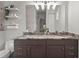Stylish bathroom features a double vanity with granite countertops and a walk-in shower with marble tiling at 4109 Cobia Ct, Palmetto, FL 34221
