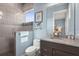 Modern bathroom featuring gray tiled walls, a glass shower, and granite countertops at 4109 Cobia Ct, Palmetto, FL 34221