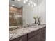 Bathroom vanity with granite countertop, dark wood cabinets, and a large mirror at 4109 Cobia Ct, Palmetto, FL 34221