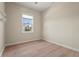 Empty bedroom featuring light floors, neutral walls, and a bright window at 4109 Cobia Ct, Palmetto, FL 34221
