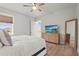 Inviting bedroom features a large window, a dresser with a TV, and access to a private bathroom at 4109 Cobia Ct, Palmetto, FL 34221