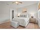 Well-lit bedroom with a ceiling fan, neutral decor, and a comfortable king-sized bed with luxury linens at 4109 Cobia Ct, Palmetto, FL 34221