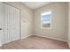 Bedroom showcasing laminate floors, a double door closet, and a bright window at 4109 Cobia Ct, Palmetto, FL 34221