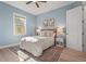 Cozy bedroom with light blue walls, complemented by a decorative rug and stylish furnishings at 4109 Cobia Ct, Palmetto, FL 34221