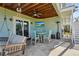Covered patio with wooden ceiling, swing, fan, and dining set creating a relaxing outdoor space at 4109 Cobia Ct, Palmetto, FL 34221