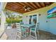Inviting covered patio with a dining table, chairs, ceiling fan, TV, and view of the swimming pool at 4109 Cobia Ct, Palmetto, FL 34221