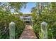 Dock with weathered wood and sturdy green posts provides access to the waterfront and boat lift at 4109 Cobia Ct, Palmetto, FL 34221