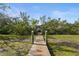 Dock with weathered wood and sturdy green posts provides access to the waterfront and boat lift at 4109 Cobia Ct, Palmetto, FL 34221