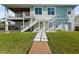 Exterior of a two-story home with a walkway and lush green grass leading to the back entrance at 4109 Cobia Ct, Palmetto, FL 34221