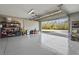 Bright, oversized three-car garage with epoxy floors, garage doors, and outdoor views at 4109 Cobia Ct, Palmetto, FL 34221