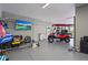 An oversized three-car garage with epoxy floors has a tv, golf cart, and lots of space at 4109 Cobia Ct, Palmetto, FL 34221
