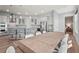 Spacious kitchen with stainless steel appliances, pendant lighting and a large dining table with seating for eight at 4109 Cobia Ct, Palmetto, FL 34221