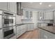 Modern kitchen features stainless steel appliances, gray cabinets, and granite countertops at 4109 Cobia Ct, Palmetto, FL 34221