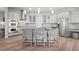Modern kitchen with stainless steel appliances, gray cabinets, granite countertops, and island with bar seating at 4109 Cobia Ct, Palmetto, FL 34221