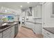 Modern open concept kitchen features gray cabinets and granite countertops with stainless steel appliances at 4109 Cobia Ct, Palmetto, FL 34221