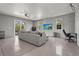 Spacious bonus room with a large sectional couch, TV, desk, and sliding doors to the outside deck at 4109 Cobia Ct, Palmetto, FL 34221