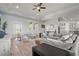 Bright living room features a large gray sectional, light wood floors, and neutral decor at 4109 Cobia Ct, Palmetto, FL 34221
