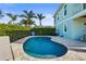 Outdoor swimming pool surrounded by stone, lush privacy landscaping, and ample patio space at 4109 Cobia Ct, Palmetto, FL 34221